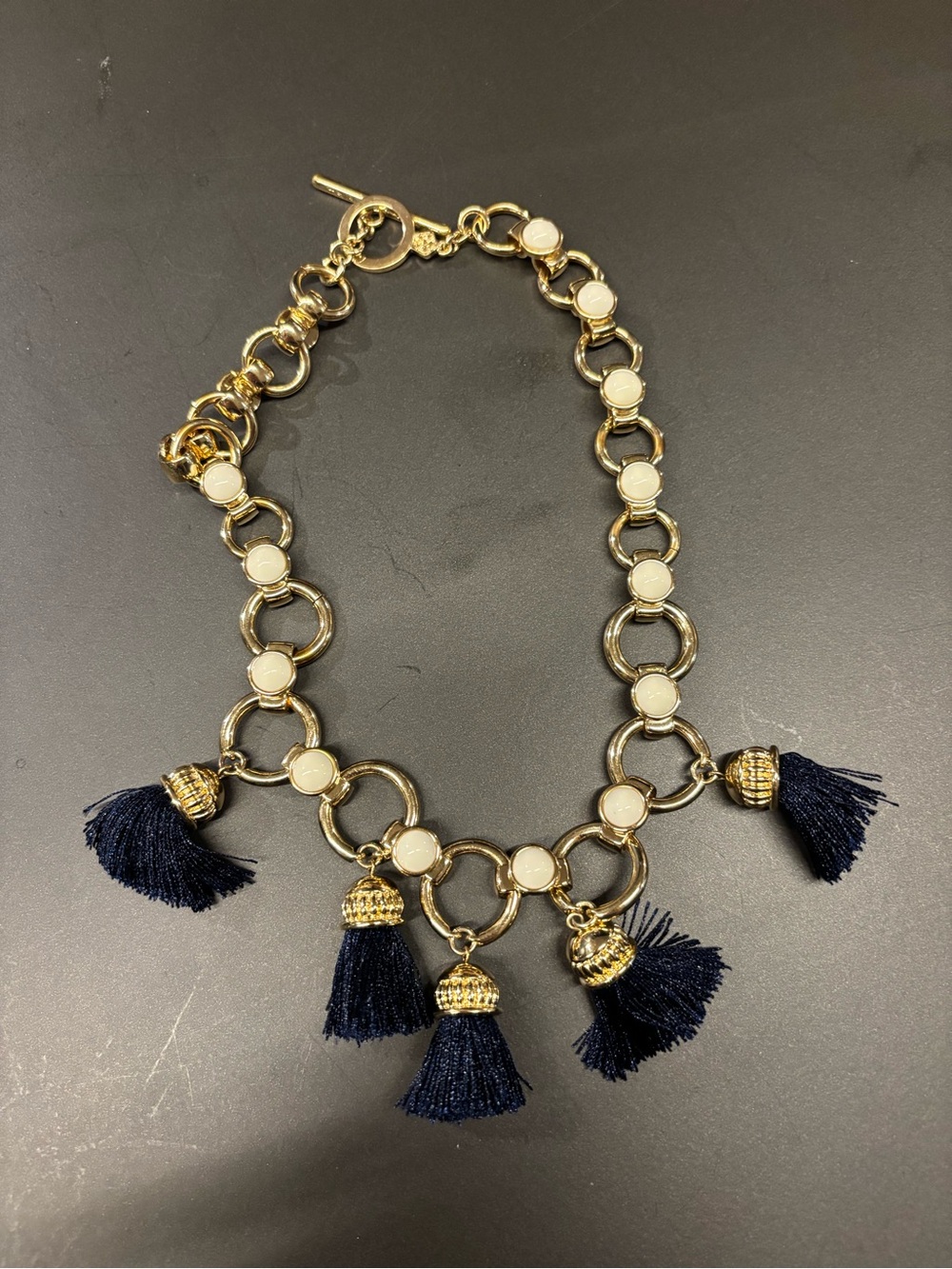 Trina Turk Gold Chain Necklace with Navy Tassels and white details. 10”